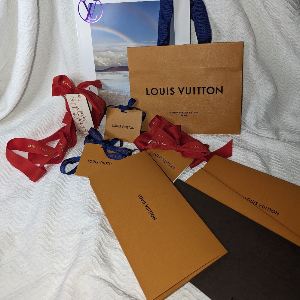 Louis Vuitton shopping bags, tags, and magazine